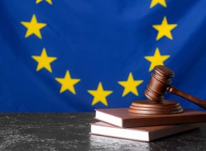 Gavel of judge with books against European Union flag